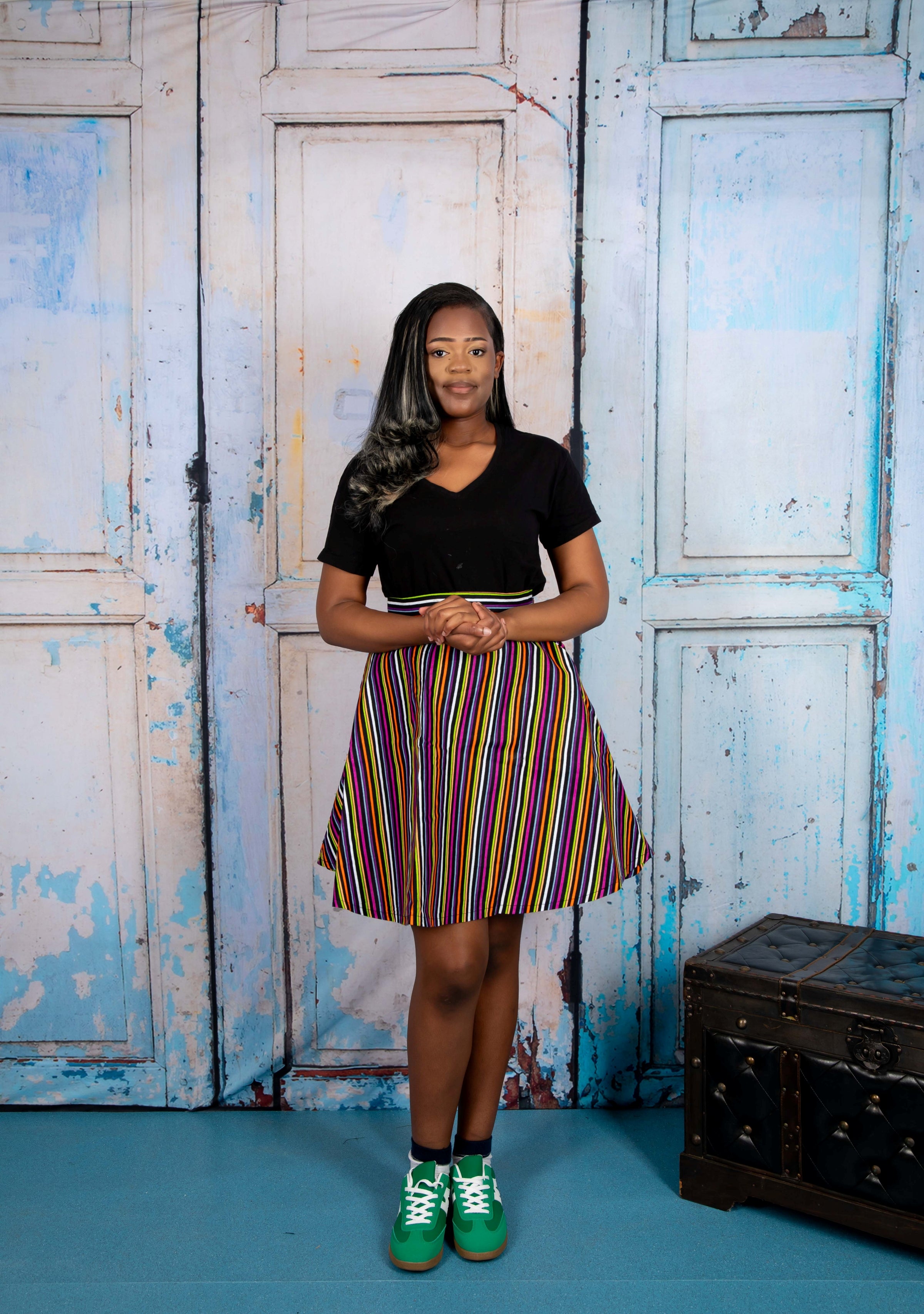 Mini circle skirt with vibrant stripy African print fabric, featuring bold, multicolored horizontal and vertical stripes. Chic mini circle skirt in bold, stripy African print—featuring vibrant multicolor patterns and a playful, flared silhouette perfect for standout styling