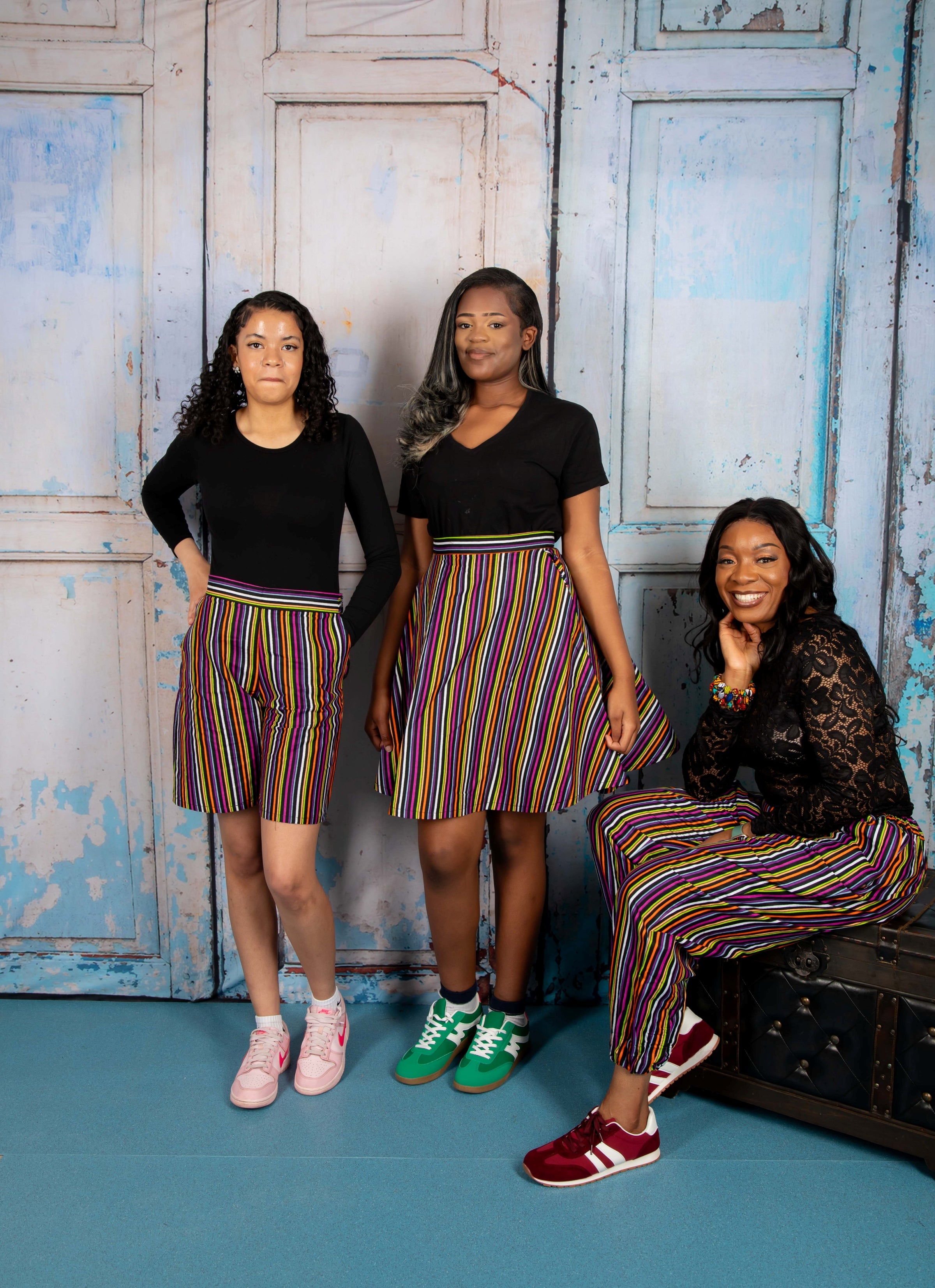Mini circle skirt with vibrant stripy African print fabric, featuring bold, multicolored horizontal and vertical stripes. Chic mini circle skirt in bold, stripy African print—featuring vibrant multicolor patterns and a playful, flared silhouette perfect for standout styling